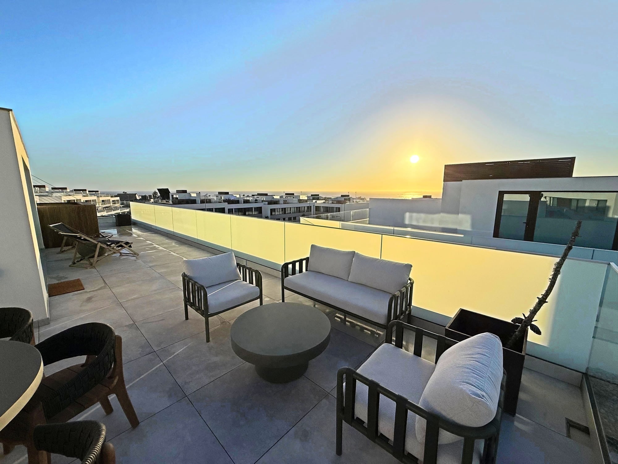 The lounge seating on the Blue Cove terrace at sunset